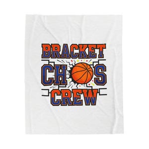 May include: White blanket with the words "BRACKET CHAOS CREW" in orange and blue lettering. A basketball graphic is in the center, breaking through a wall. The blanket is a soft, cozy item.