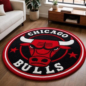 May include: A round rug featuring the Chicago Bulls logo. The rug has a black center with a red bull head and white horns. The words "CHICAGO" and "BULLS" are in white. A red and white border surrounds the logo.