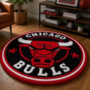 May include: A round rug featuring the Chicago Bulls logo. The rug has a black center with a red bull head and white lettering. A red and white border surrounds the logo. The rug is on a hardwood floor.