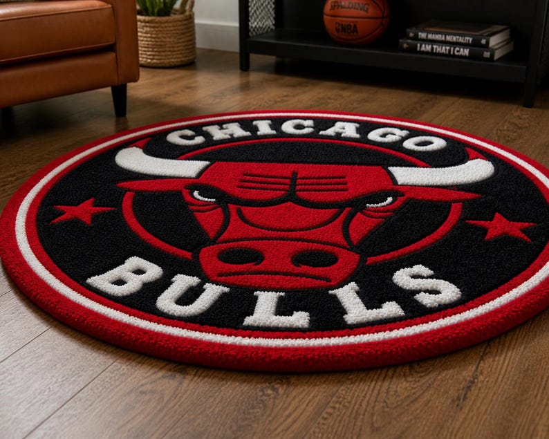 May include: A round rug featuring the Chicago Bulls logo. The rug has a black background with a red bull head and white lettering. The border is red and white. The rug is on a wooden floor.