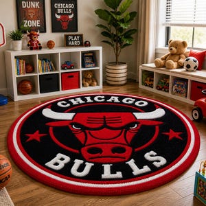 May include: A round Chicago Bulls logo rug with a red and white border. The rug features the team's bull logo in red and white against a black background. The word "CHICAGO" arches above the logo, and "BULLS" is below.