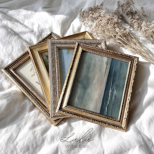 May include: A collection of vintage framed art pieces with ornate gold frames. The artwork within the frames features soft, muted colors, including blues, greens, and beige. The frames are arranged on a white, textured surface. The text "Lulu Vintage Art" is at the bottom.