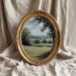 May include: An oval landscape painting in a gold ornate frame. The artwork shows a green field, trees, and a blue sky with clouds. The frame has decorative carvings. The text "Lulu Vintage Art" is at the bottom.
