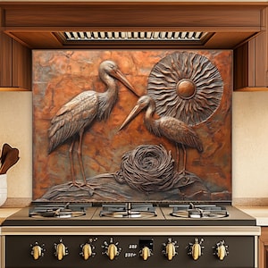 May include: A copper-toned backsplash features a relief sculpture of two herons, a nest, and a sun design. The backsplash is installed above a black and gold stove with six burners and gold knobs. Wooden cabinets frame the stove.