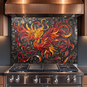 May include: A kitchen backsplash featuring a mosaic of a phoenix in vibrant shades of red, orange, and yellow against a dark, textured background. The artwork is positioned behind a stainless steel gas range and a large copper-toned range hood.