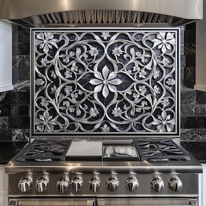 May include: Stainless steel gas range with a decorative floral backsplash. The backsplash features a silver floral design against a dark background. The range has multiple burners and control knobs, and is set in a modern kitchen.