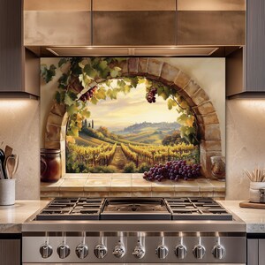 May include: A kitchen backsplash featuring a painted Tuscan vineyard scene. The artwork depicts a stone archway framing a view of grape vines, rolling hills, and a distant village. Clusters of purple grapes are visible.
