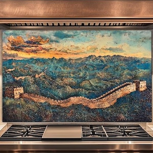 May include: A set of three ceramic nesting bowls in shades of blue, green, and white. The bowls feature a speckled glaze and a simple, modern design. The largest bowl measures approximately 6 inches in diameter.