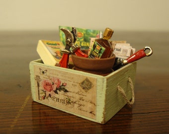 dollhouse miniatures. wooden crate in walnut wood, rope handles with articles of gardening 1:12 scale