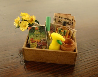 dollhouse miniatures. wooden crate in walnut wood, rope handles with articles of gardening 1:12 scale