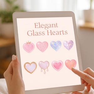 以下が含まれることがあります： タブレットには、王冠、テクスチャ加工された表面、虹色の効果を備えた、さまざまなピンク色のエレガントなガラスのハートが表示されています。「Elegant Glass Hearts」というテキストが表示されています。指が画面に触れています。