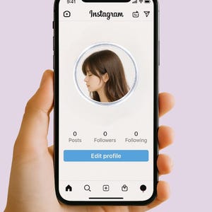 May include: A smartphone displaying an Instagram profile page. The profile picture is a side profile of a person with brown hair. The screen shows 0 posts, 0 followers, and 0 following, with an "Edit profile" button.