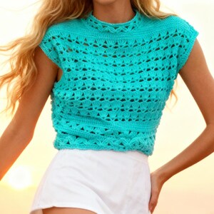 May include: A turquoise crochet top with a high neckline and cap sleeves. The top features an open, textured design and is paired with white shorts. The image captures a summery, casual style, perfect for warm weather.