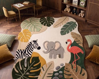 May include: An area rug with an irregular, organic shape featuring a cream-colored background. The design includes a central gray elephant, a black and white zebra, and a pink flamingo, surrounded by large, colorful tropical leaves and stones.