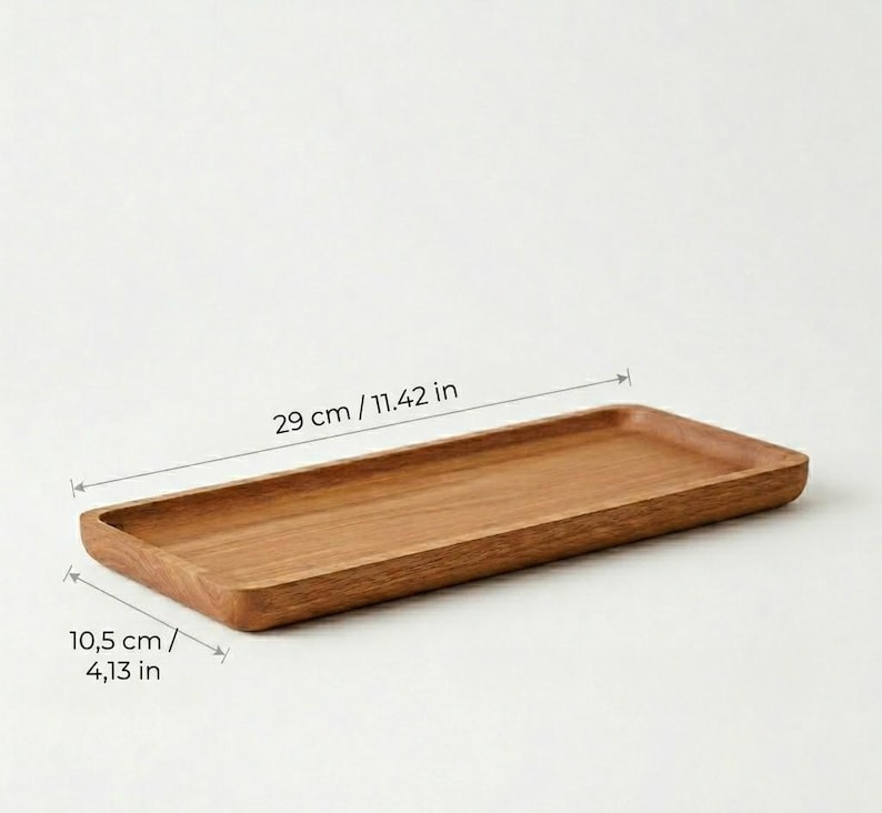 Pu&ograve; includere: Un vassoio rettangolare in legno, lungo 29 cm e largo 10,5 cm, con finitura a venatura naturale. Il vassoio ha un interno poco profondo e bordi arrotondati. Ideale per servire o esporre.