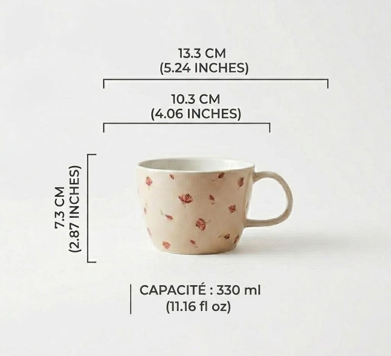 May include: A beige ceramic mug with a floral pattern of small red flowers. The mug is 2.87 inches tall, 5.24 inches wide, and 4.06 inches in diameter. It has a capacity of 11.16 fl oz.