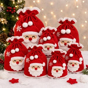 May include: A collection of red and white crochet drawstring bags featuring Santa Claus faces with white beards, red noses, and smiling expressions. Each bag is topped with a ruffled edge and decorated with small white pom-poms and snowflake motifs.