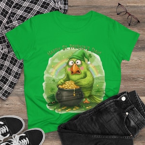 May include: Green t-shirt with a cartoon parrot wearing a green hat, holding a pot of gold coins, and the text "Happy St. Patrick's Day!". A rainbow and a green hat are also in the design. Black jeans and shoes are in the image.