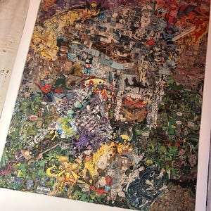 May include: A large, framed print featuring a collage of comic book panels. The artwork is a vibrant mix of colors and characters, including superheroes and villains. The print is set against a white background, with the text "DR. DOOM" visible.