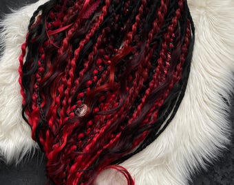 A decorative set of red and black dreadlocks. Gothic style.