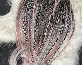 Handmade dreadlocks. Pink-gray gradient.