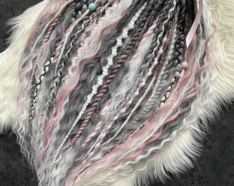 Synthetic dreadlocks in pastel grey with pink accents.