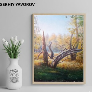 May include: A framed landscape painting of a forest scene with a fallen tree and autumn foliage. The painting is in a wooden frame and is displayed next to a white vase with white tulips and a cartoon illustration.