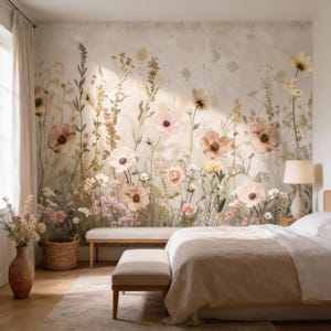 May include: A bedroom with a floral mural featuring large, soft-colored flowers in shades of pink, peach, and white. The room includes a bed with a beige comforter, a bench, and a woven basket. A lamp sits on a bedside table.