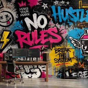 May include: A wall mural featuring vibrant graffiti art with text including STAY WILD, MAKE YOUR MARK, NO RULES, BREAK THE SYSTEM, and URBAN LEGEND. The design incorporates a winged spray paint can, a smiley face, and a lightning bolt in bright colors.