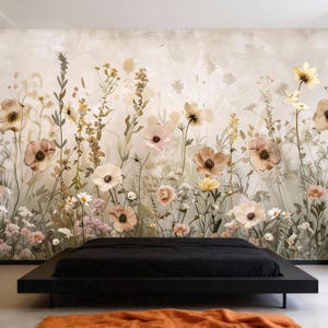 May include: A bedroom featuring a black platform bed with a black comforter. The wall behind the bed is adorned with a floral mural in soft pastel colors, including pink, beige, and yellow flowers. An orange rug is at the foot of the bed.