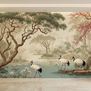 K&ouml;nnte beinhalten: Ein malerisches Wandbild, das eine ruhige Landschaft mit einem ruhigen See, &uuml;ppigen B&auml;umen und zarten rosa Bl&uuml;ten darstellt. Drei elegante wei&szlig;e und schwarze Kraniche stehen anmutig am Wasser und verleihen der Szene einen Hauch von nat&uuml;rlicher Sch&ouml;nheit.