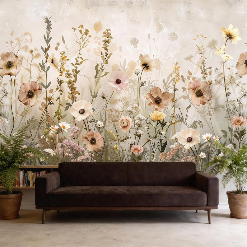 May include: A dark brown sofa with wooden legs sits in front of a floral wallpaper. The wallpaper features a variety of flowers in shades of pink, cream, and yellow, with green foliage. Potted plants are on either side of the sofa.