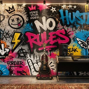 May include: A wall mural featuring vibrant graffiti art with text including STAY WILD, MAKE YOUR MARK, NO RULES, BE REAL, and FOREVER. The design incorporates a smiley face, lightning bolt, and a spray paint can with wings. An electric guitar stands in front.