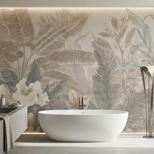 May include: A modern bathroom with a large, white, oval bathtub. The wall features a large mural of tropical leaves in shades of beige, gray, and green. A concrete sink and a tall, silver floor lamp complete the spa-like atmosphere.