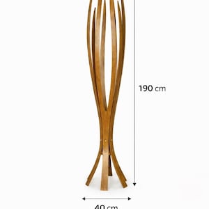 May include: A tall wooden coat rack with a distinctive design. The rack is 190 cm tall and 40 cm wide at the base. It features multiple curved wooden slats that extend upwards, creating a decorative and functional piece for any entryway or room.