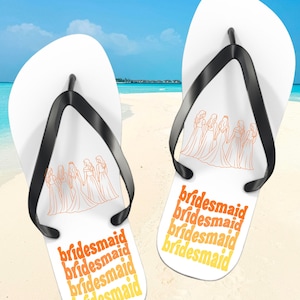 May include: A white ceramic mug with a black handle and the text "But First, Coffee" in a handwritten style. The mug is on a white surface. The mug is approximately 4 inches tall.