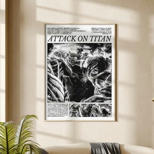 May include: A framed black and white Attack on Titan poster. The poster features manga-style illustrations of characters in action, with the title "ATTACK ON TITAN" in bold letters. The poster is displayed on a wall above a sofa.