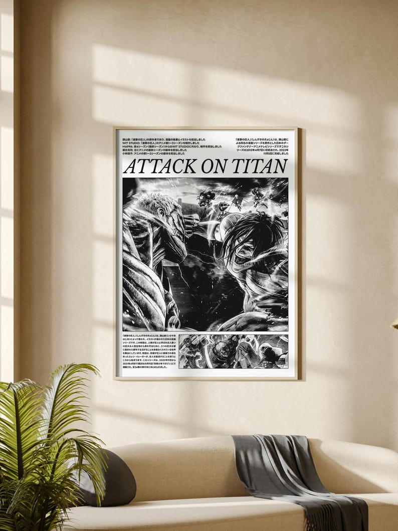 May include: A framed black and white Attack on Titan poster. The poster features manga-style illustrations of characters in action, with the title "ATTACK ON TITAN" in bold letters. The poster is displayed on a wall above a sofa.
