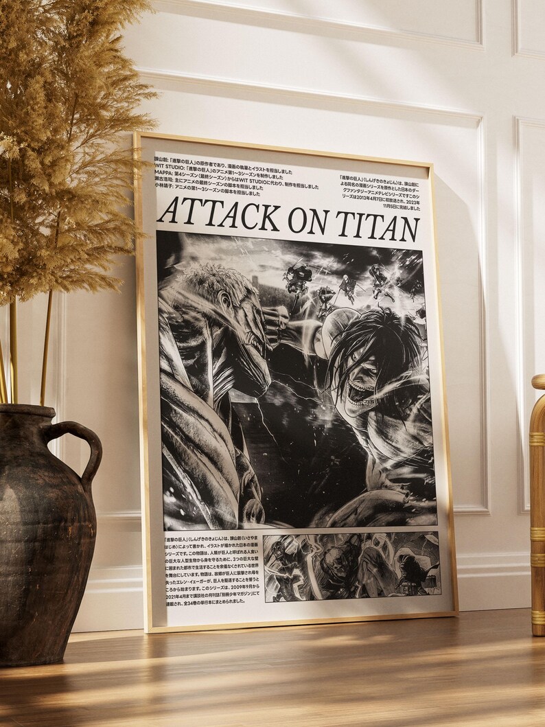 May include: A framed black and white Attack on Titan poster. The poster features manga-style illustrations of characters in action, with the title "ATTACK ON TITAN" prominently displayed. The frame is a light wood color.