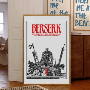 May include: A framed poster featuring the word "BERSERK" in red, with Japanese text below. The artwork depicts a warrior figure with swords and a graphic design. Two other framed prints with the text "meet me at the beach" are visible in the background.