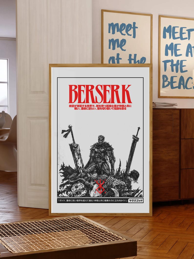 May include: A framed poster featuring the word "BERSERK" in red, with Japanese text below. The artwork depicts a warrior figure with swords and a graphic design. Two other framed prints with the text "meet me at the beach" are visible in the background.