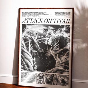 May include: Framed black and white Attack on Titan poster. The artwork features detailed illustrations of characters and action scenes from the anime series. The poster is displayed in a brown wooden frame, leaning against a white wall.
