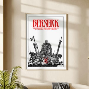 May include: A framed black and white poster with the word "BERSERK" in red. The poster features a detailed illustration of a warrior figure with swords and other figures. Japanese text is also present.