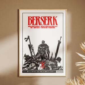 May include: A framed poster featuring the word "BERSERK" in red, above a black and white illustration of a warrior with swords. Japanese text is present at the top and bottom of the poster.