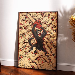 May include: A rectangular wall art print featuring a central black cat holding a red chainsaw above its head, surrounded by a dense crowd of aggressive, snarling cream-colored cats with red accents, all set against a dark, textured background.