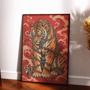 May include: A rectangular framed wall art print featuring a detailed illustration of a tiger with orange and black stripes, wrapped in dark metal chains. The tiger is set against a vibrant red background with stylized swirling cloud patterns.