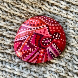 Hand painted rock with inspirational saying on the back.