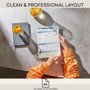 May include: A session notes template is held by a person wearing an orange long-sleeved shirt. The template has a blue header and is filled with blank fields. A gray notebook and a glass of orange-infused water sit nearby. The text "CLEAN & PROFESSIONAL LAYOUT" is at the top.