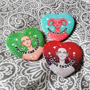 May include: A set of three ceramic mugs with a speckled, matte finish in cream, light grey, and dark grey. Each mug has a simple, minimalist design and a rounded handle.