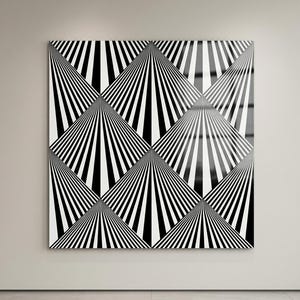 May include: A large, square black and white geometric art piece with a repeating pattern of radiating lines. The artwork is mounted on a neutral-colored wall in a modern interior setting. The lines create a sense of depth and movement.